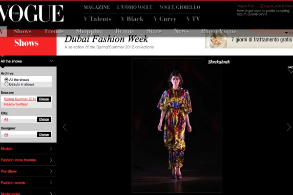 Model in a bold red-yellow fire-printed jumpsuit by Shrekahnth on the runway at Dubai Fashion Week Spring/Summer 2012, published on Vogue Italia.
